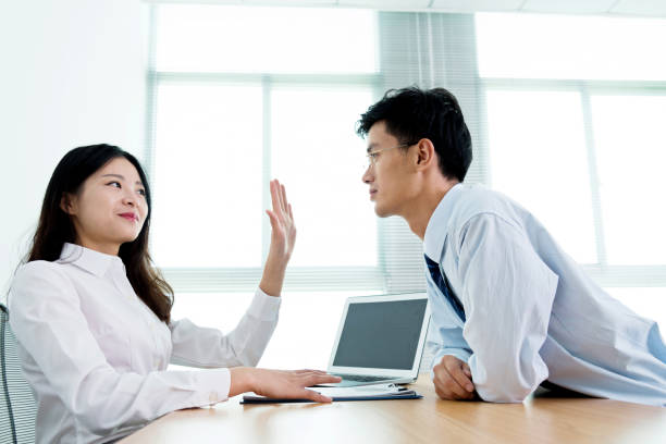 woman-gesturing-no-with-her-hand-to-male-coworker