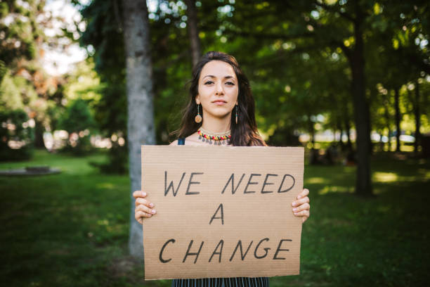 lady-holding-we-need-a-change-poster