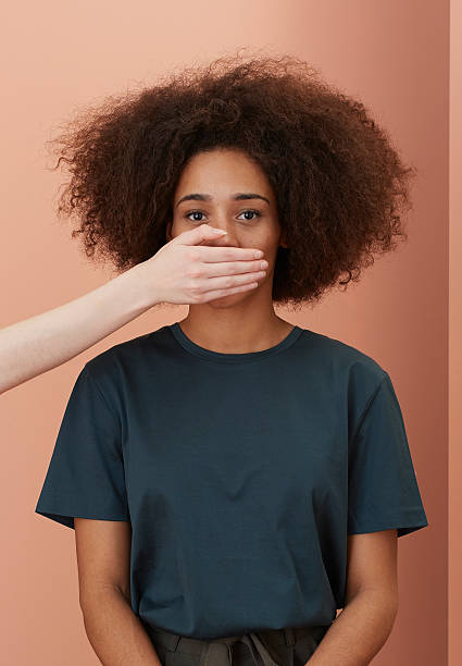 woman-being-silenced-with-hand-on-mouth